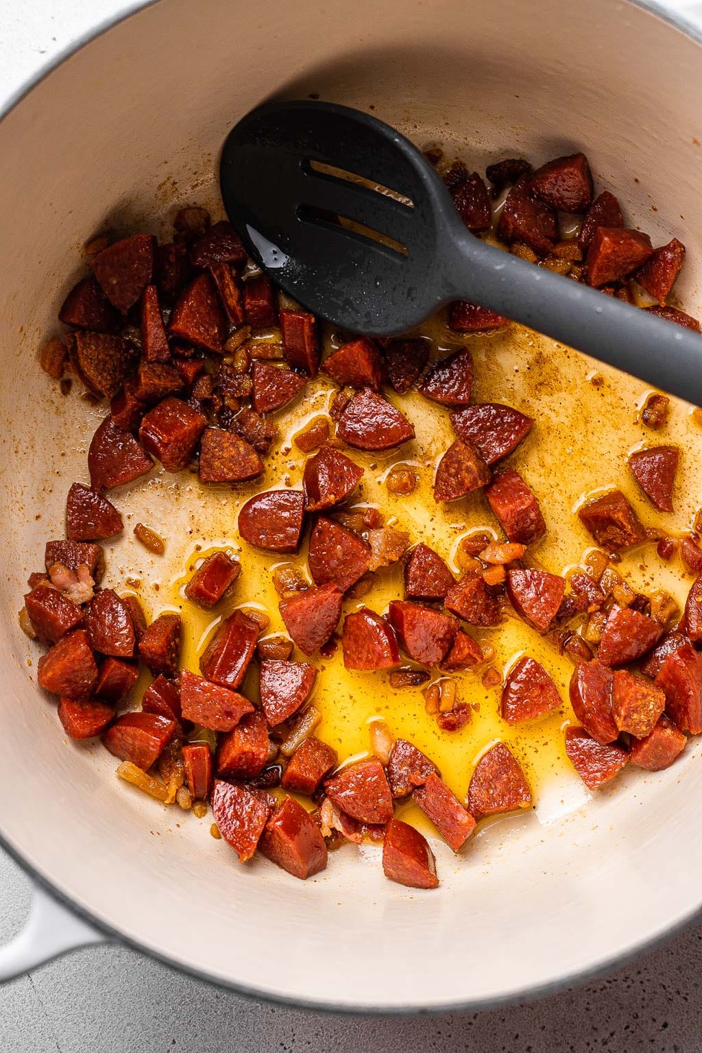 Pancetta and pepperoni browning in a dutch oven 