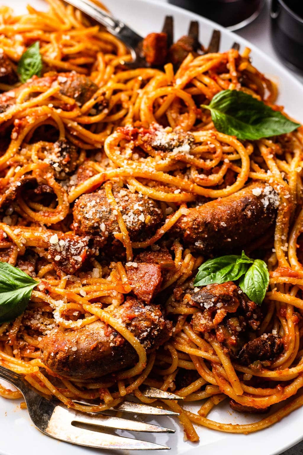 A plate of pasta tossed in meatball and sausage Sunday sauce 