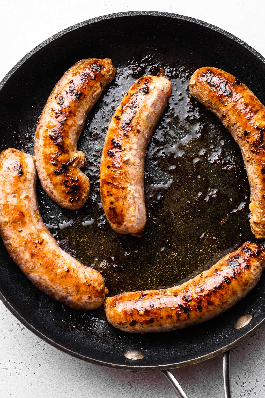Browned Italian sausage links in a skillet 