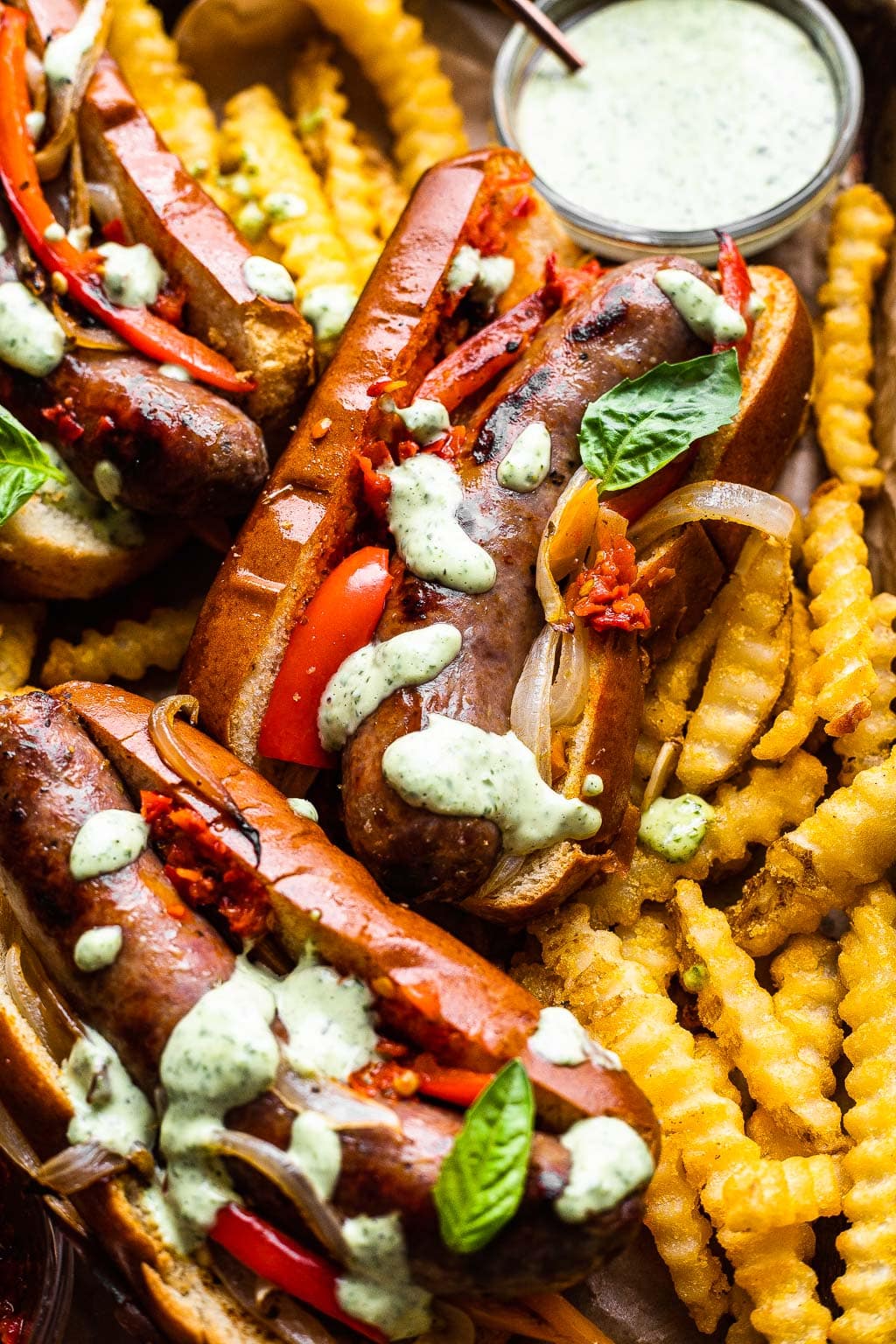 Three Italian sausage sandwiches with fries 