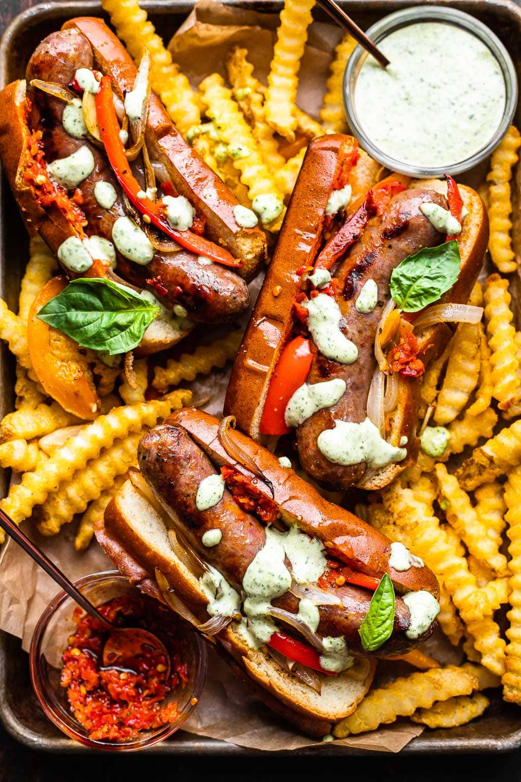 Three Italian sausage sandwiches with fries 