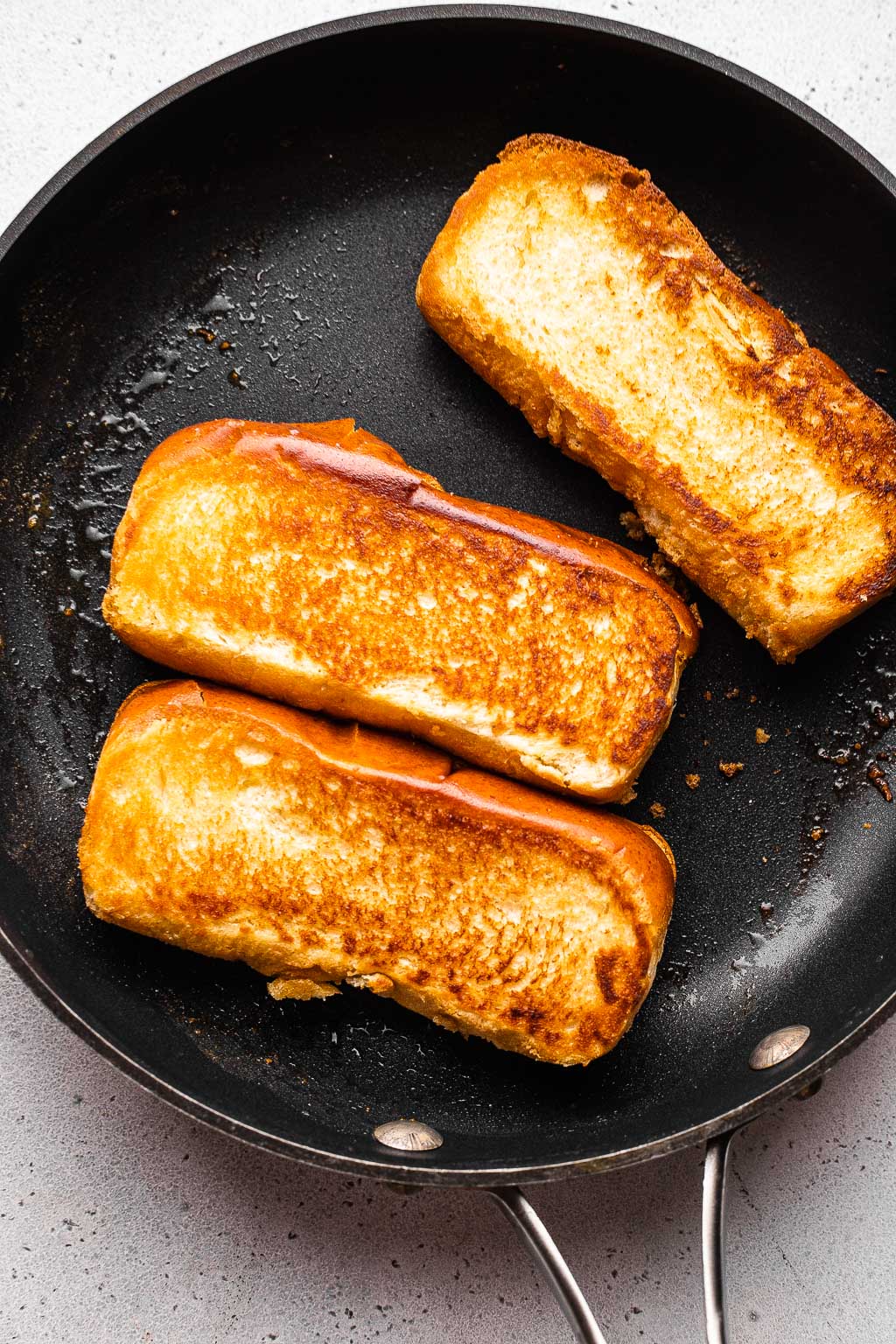 Toasted brioche buns in a skillet 