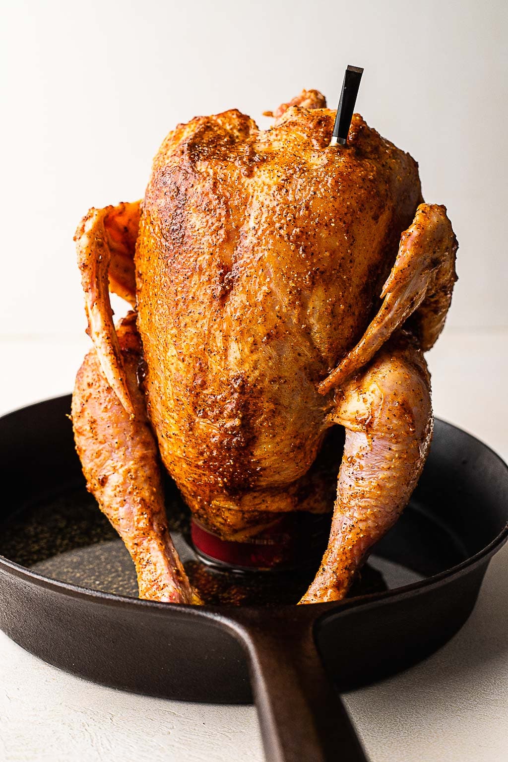 A whole chicken on a beer can, ready to be cooked 