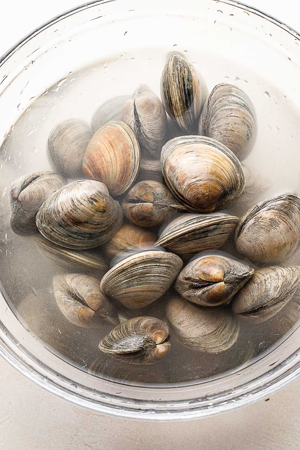 Process shot showing how to prep clams for grilling 