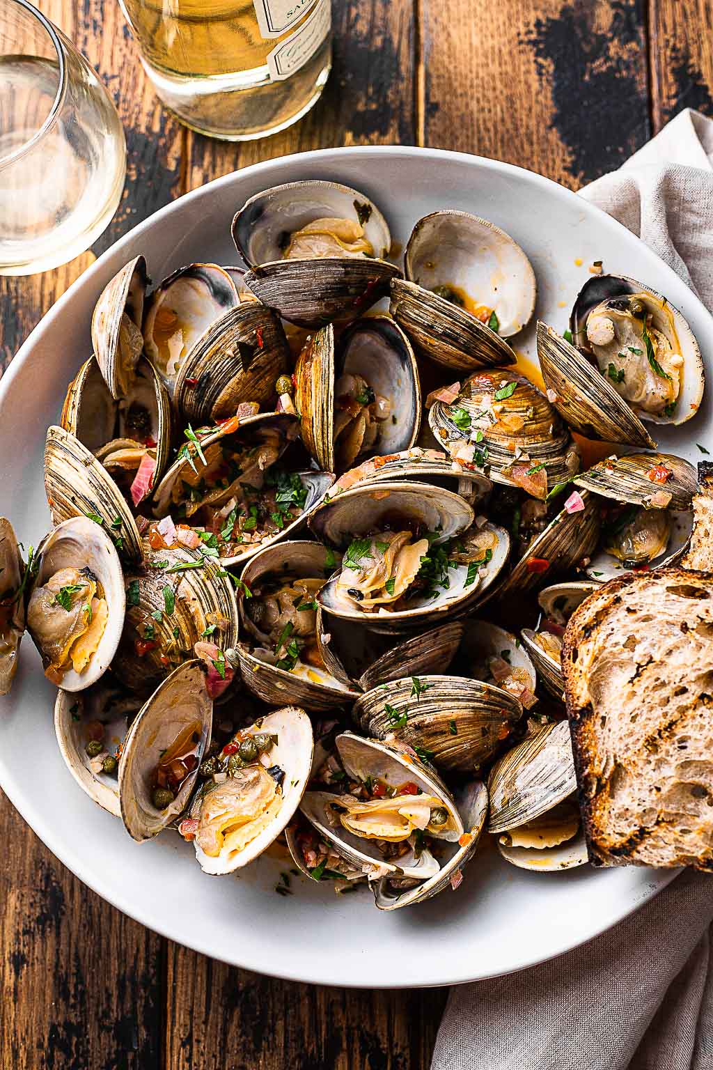 Grilled littleneck clams in a serving bowl 