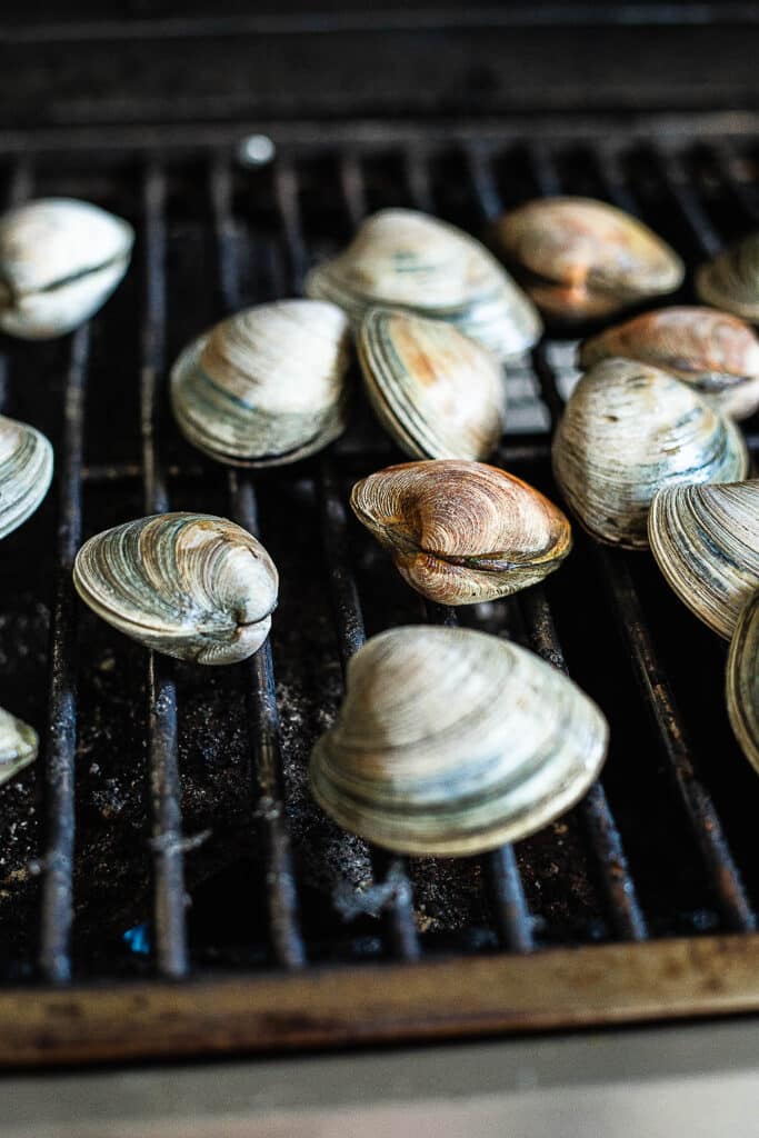 Process shot showing clams on the grill