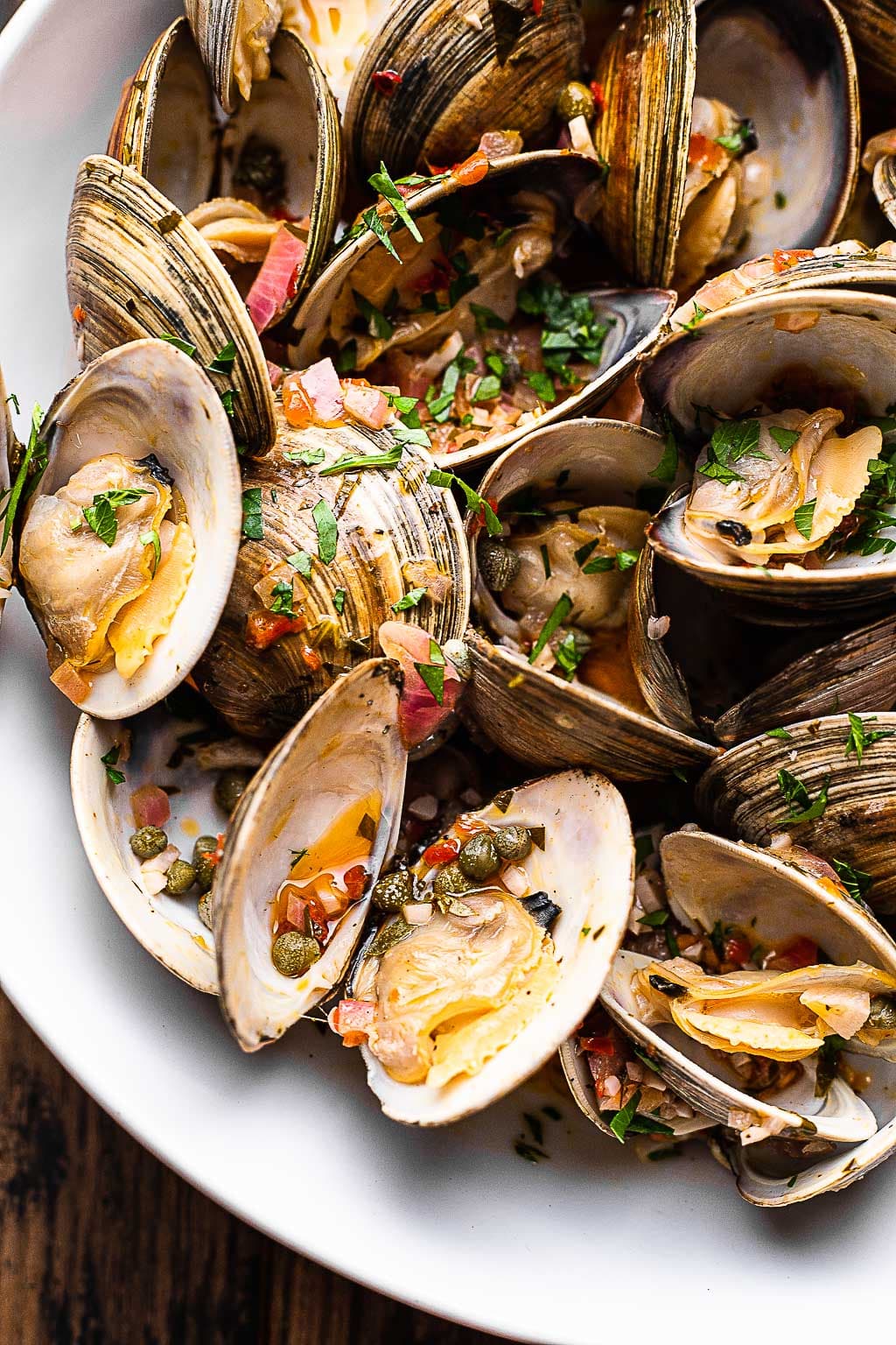 Grilled littleneck clams in a serving bowl 