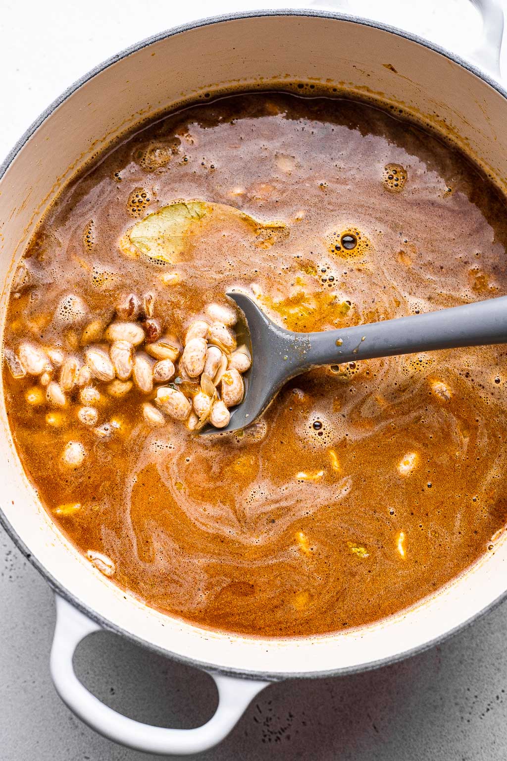 Process shot showing cooked drunken beans 
