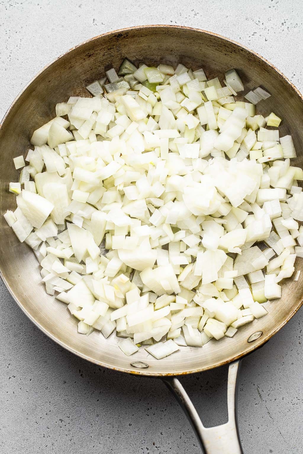 Diced onions in a skillet. 