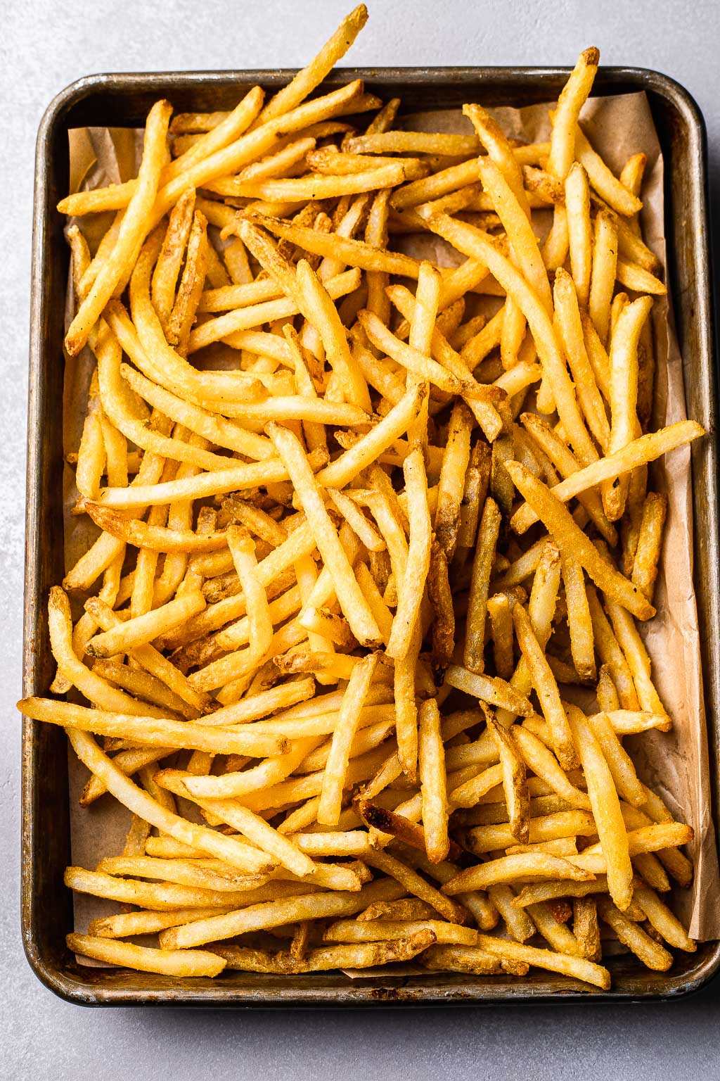 Cooked french fries on a sheet pan 