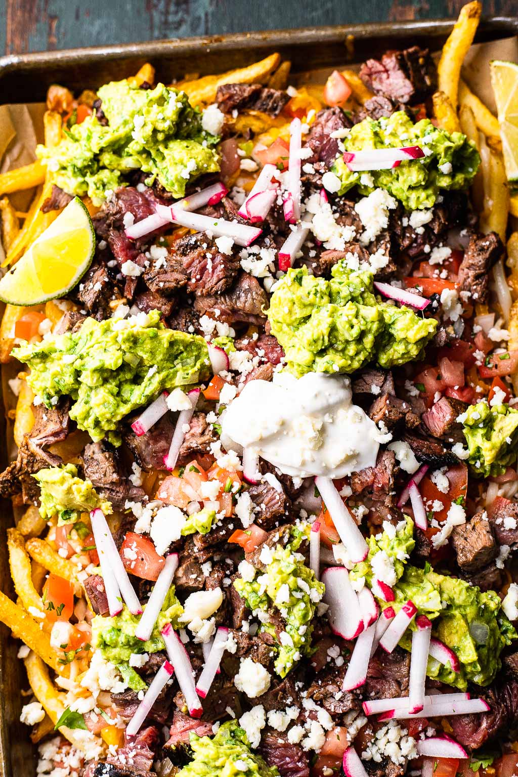 Carne asada loaded fries, seen from above 