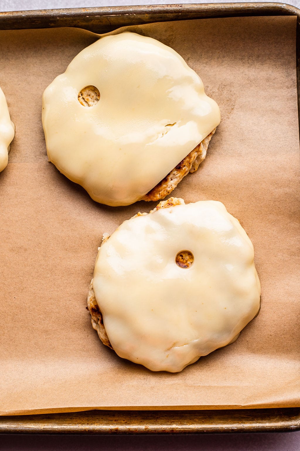 Chicken patties topped with melted Swiss cheese 