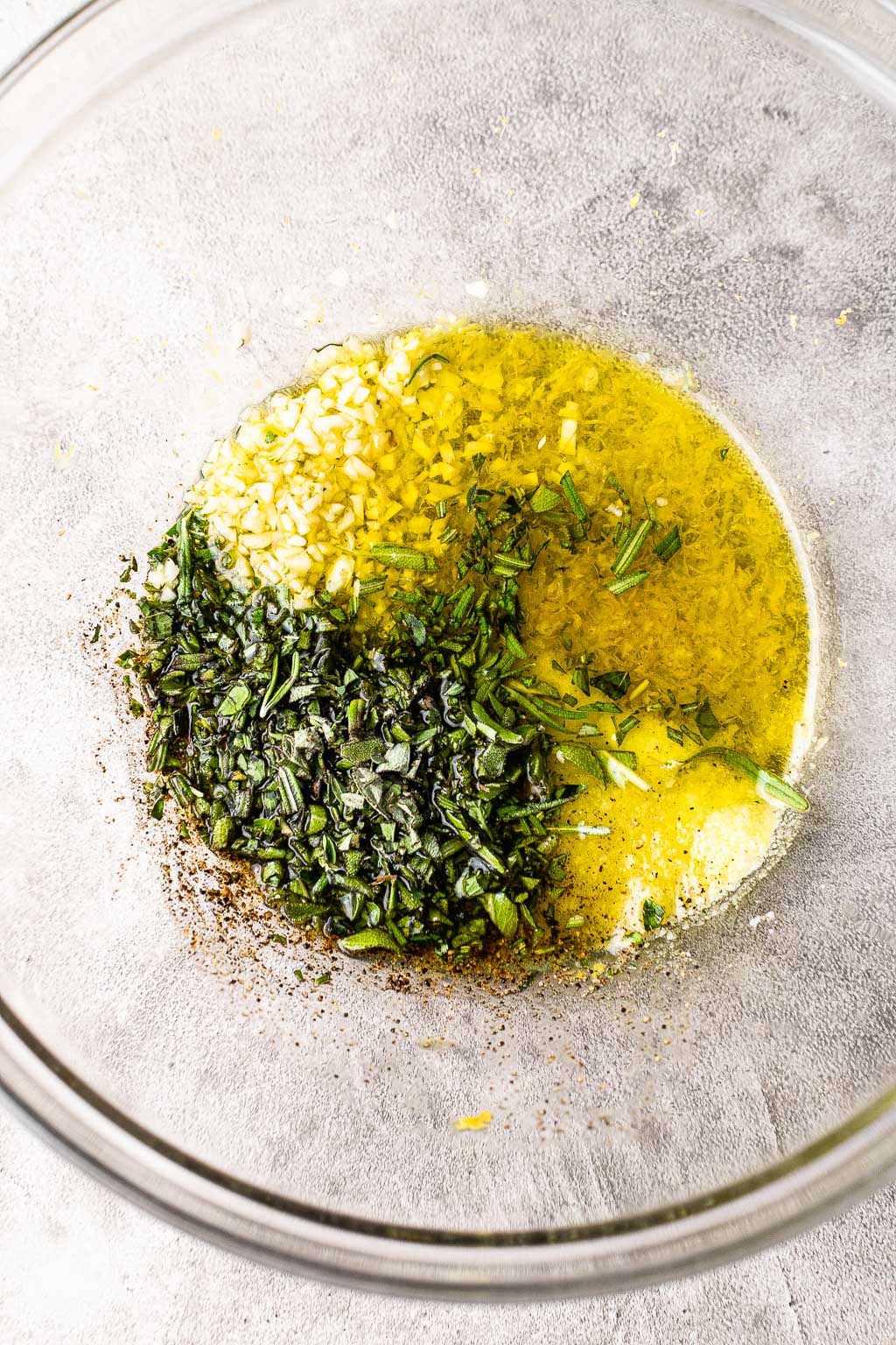Lemon herb chicken marinade in a mixing bowl. 