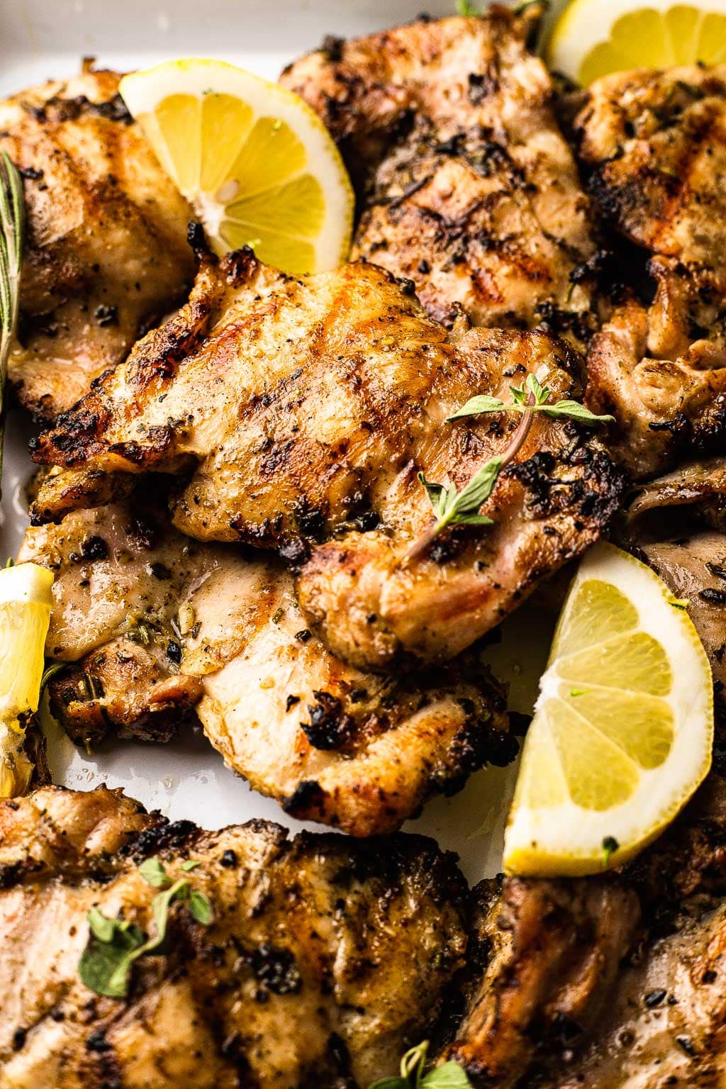 Grilled chicken thighs with fresh lemon and herbs. 