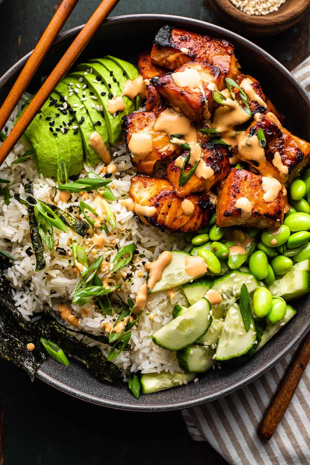 Salmon and rice bowl with toppings and sauce 