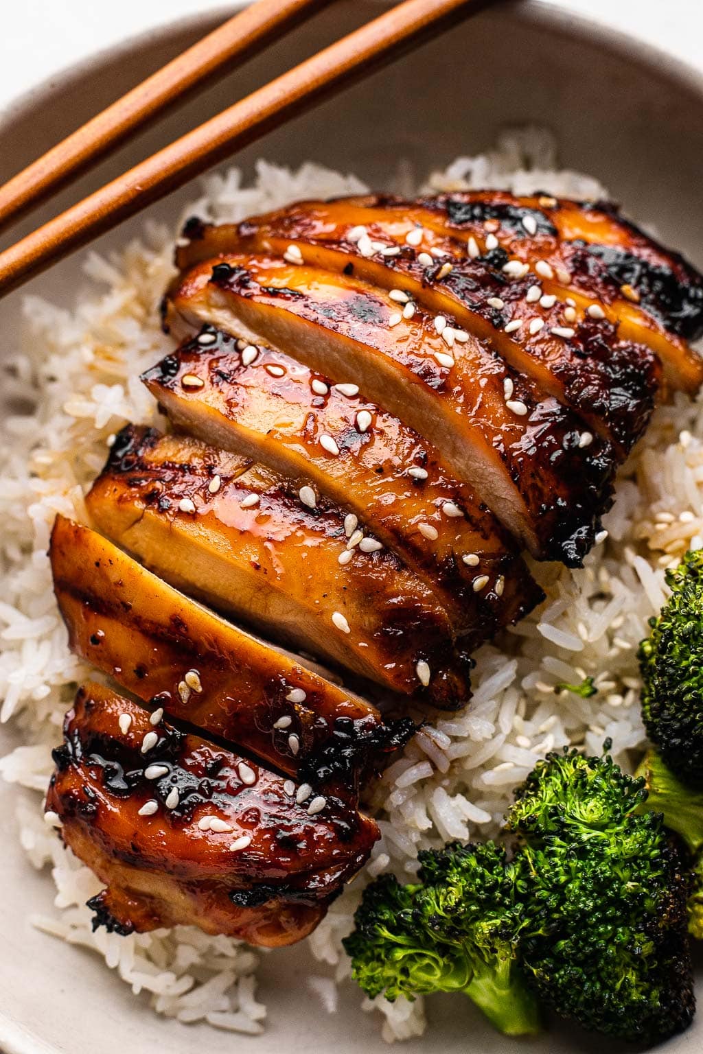 A grilled teriyaki chicken bowl with broccoli 