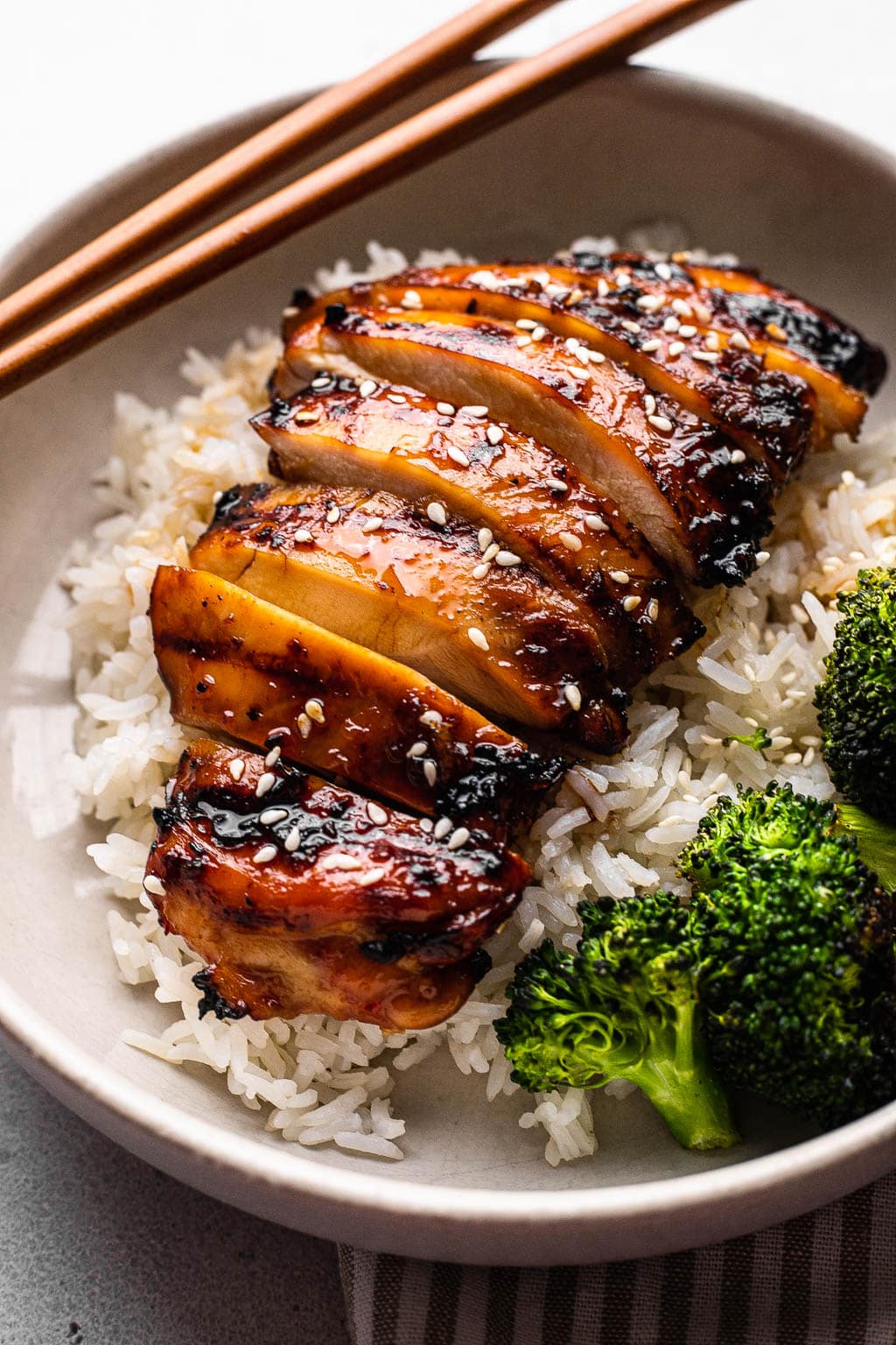 A grilled teriyaki chicken bowl with broccoli 
