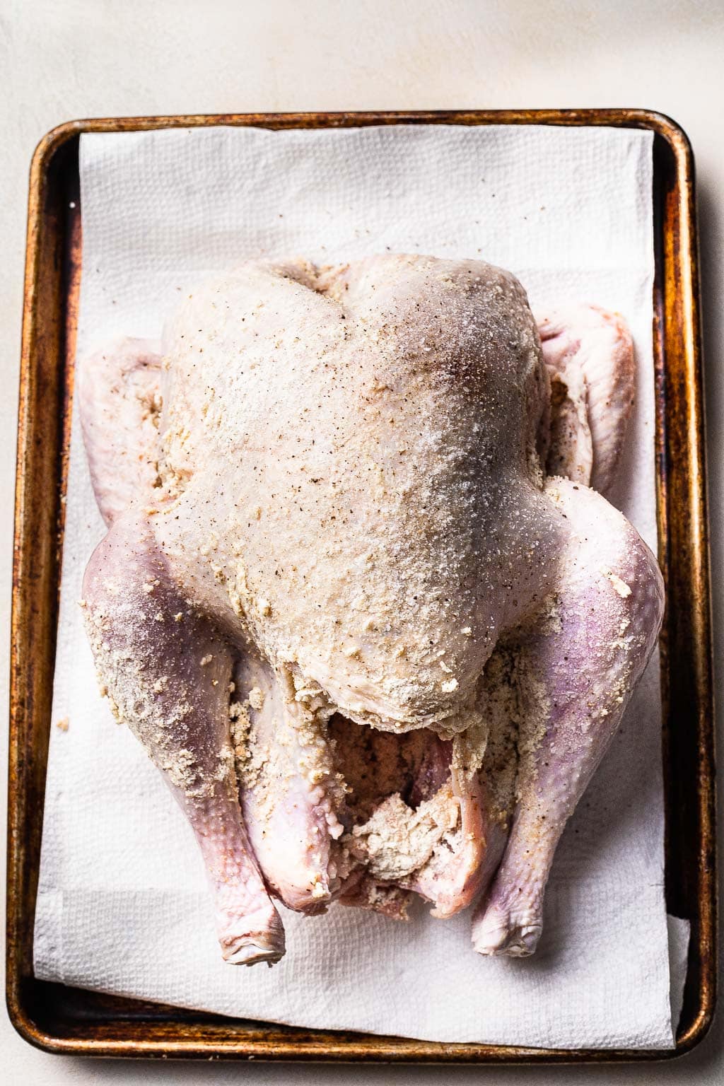 A turkey coated in dry brine