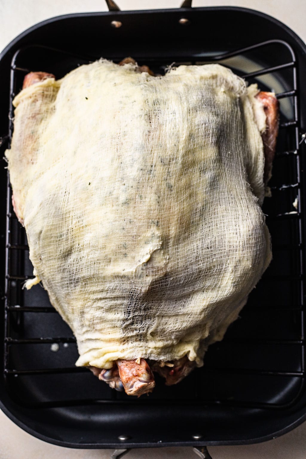 A whole turkey wrapped in butter-soaked cheesecloth 