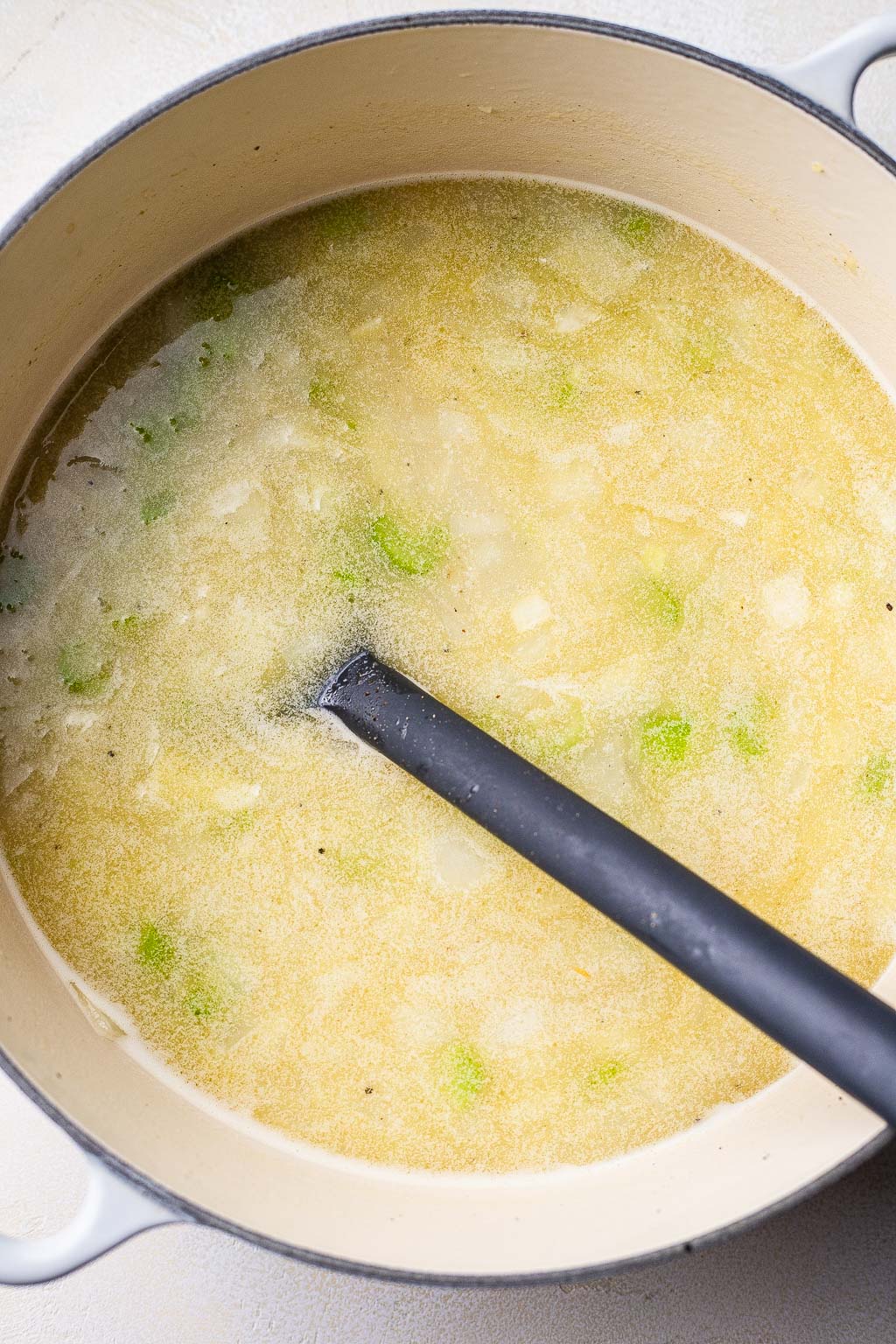 Chicken broth and vegetables in a pot 
