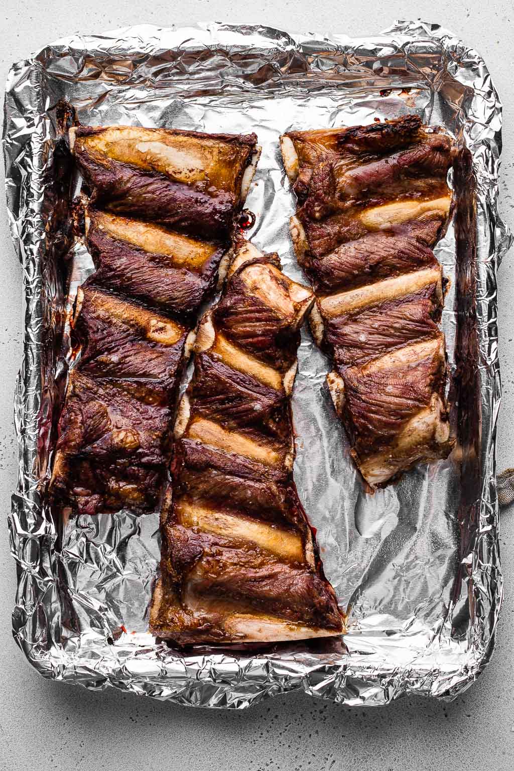 Roasted beef finger ribs on a baking sheet 