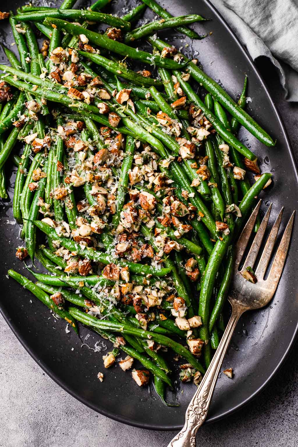 A platter of sauteed green beans topped with gremolata 