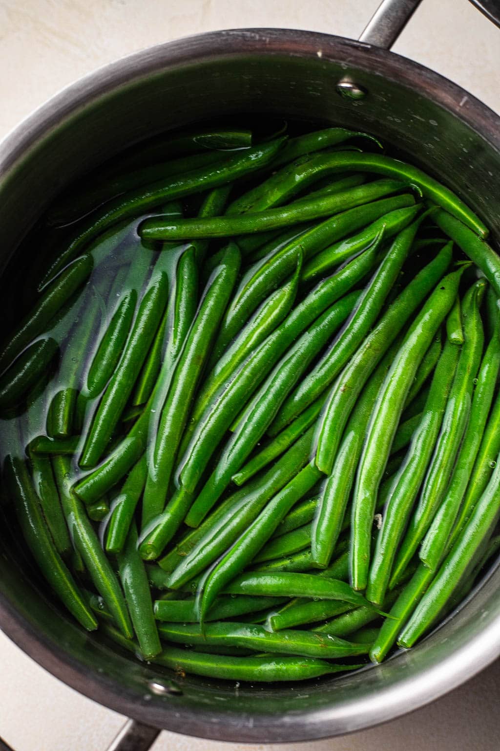 Fresh green beans blanching in water 