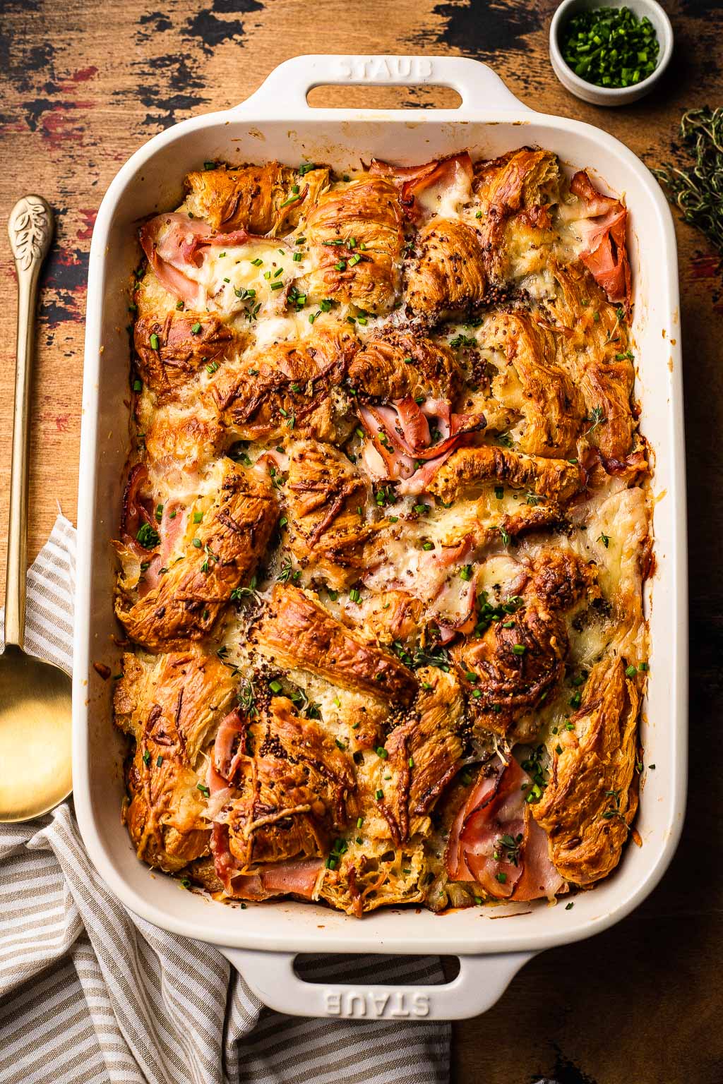 overhead view of ham and cheese croissant bake in a baking dish