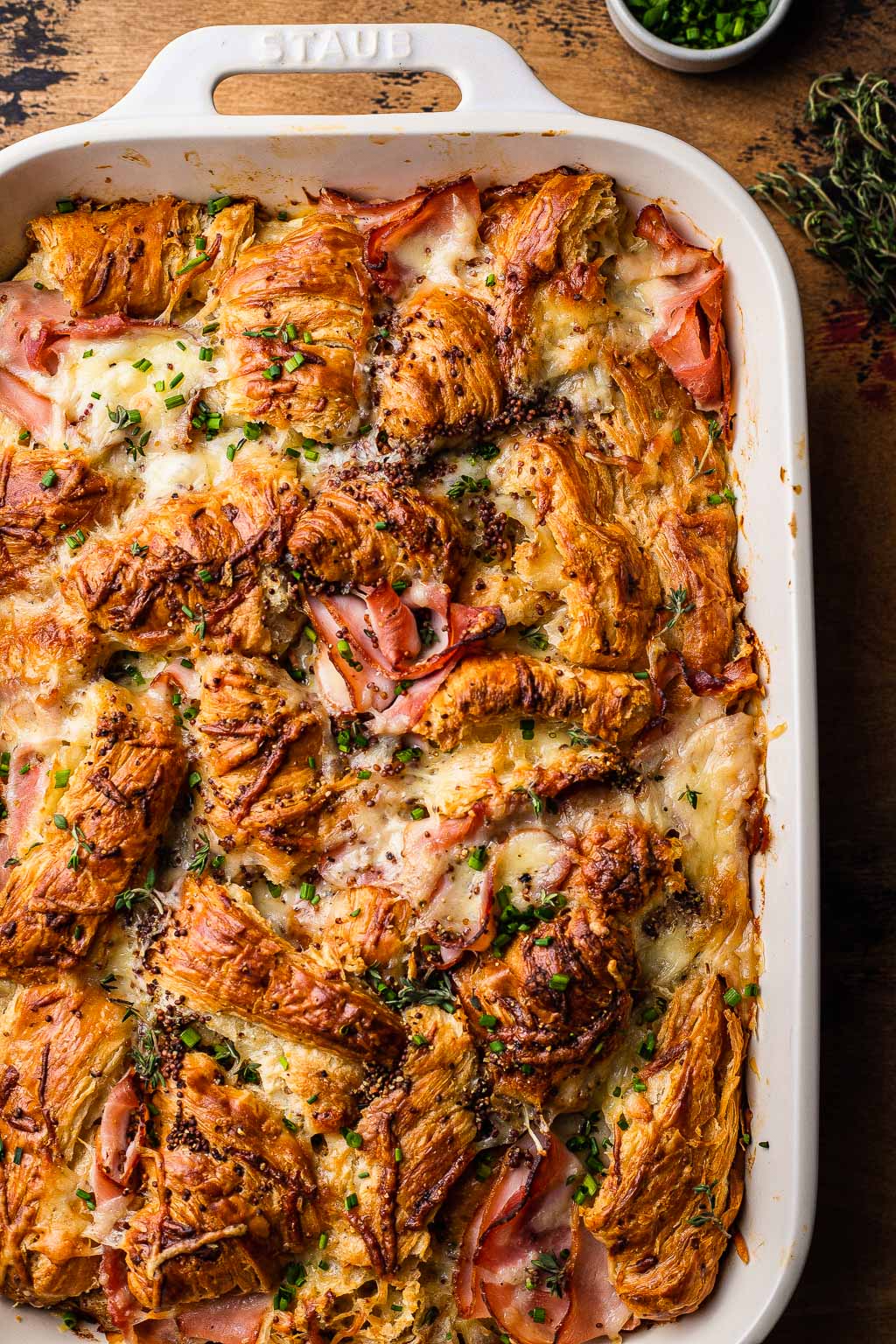 overhead view of ham and cheese croissant bake in a baking dish