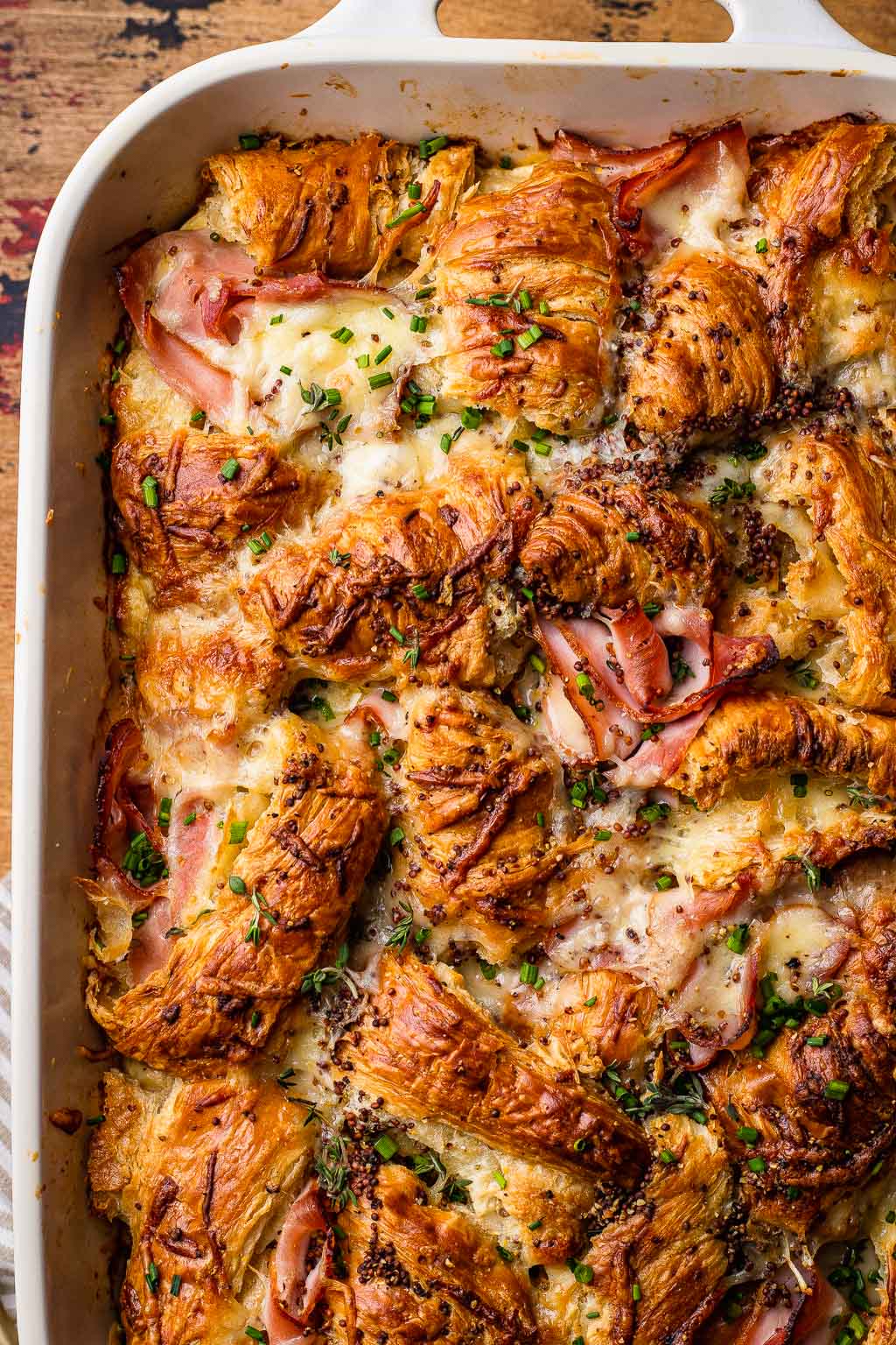 overhead view of ham and cheese croissant bake in a baking dish