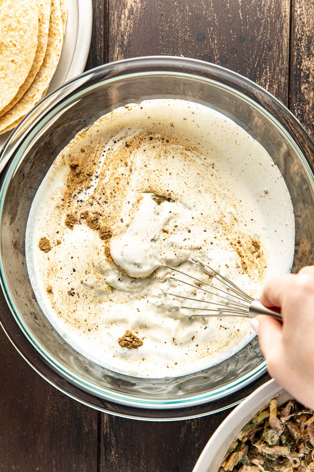 turkey enchilada sauce being whisked in a mixing bowl