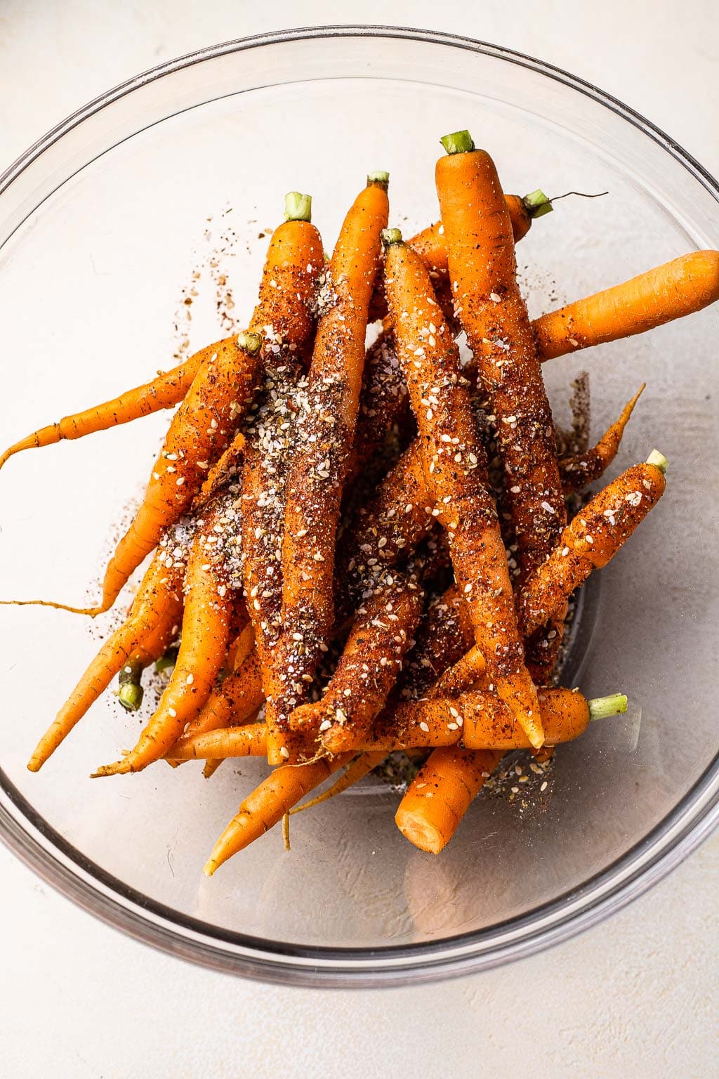 Whole carrots and spices in a mixing bowl 