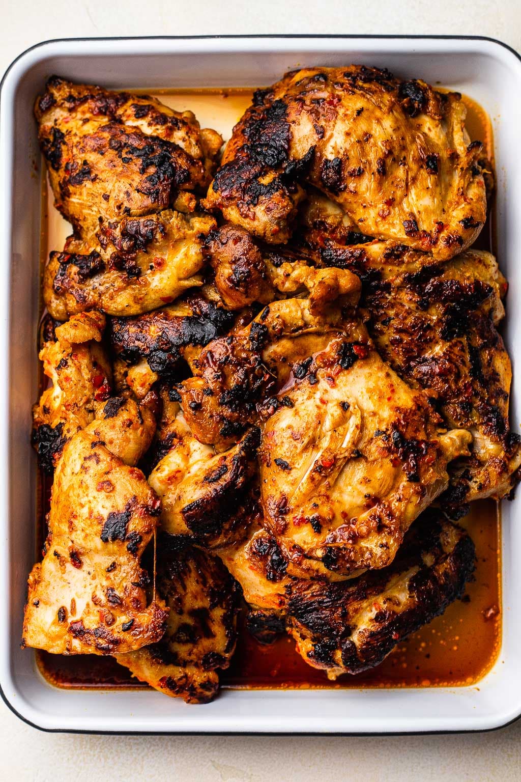 Grilled harissa chicken in a baking dish 