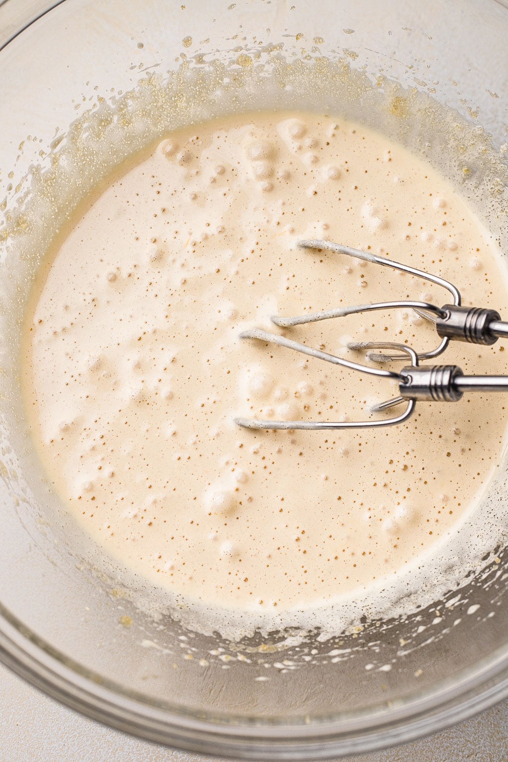 Whipped eggs and sugar in mixing bowl 