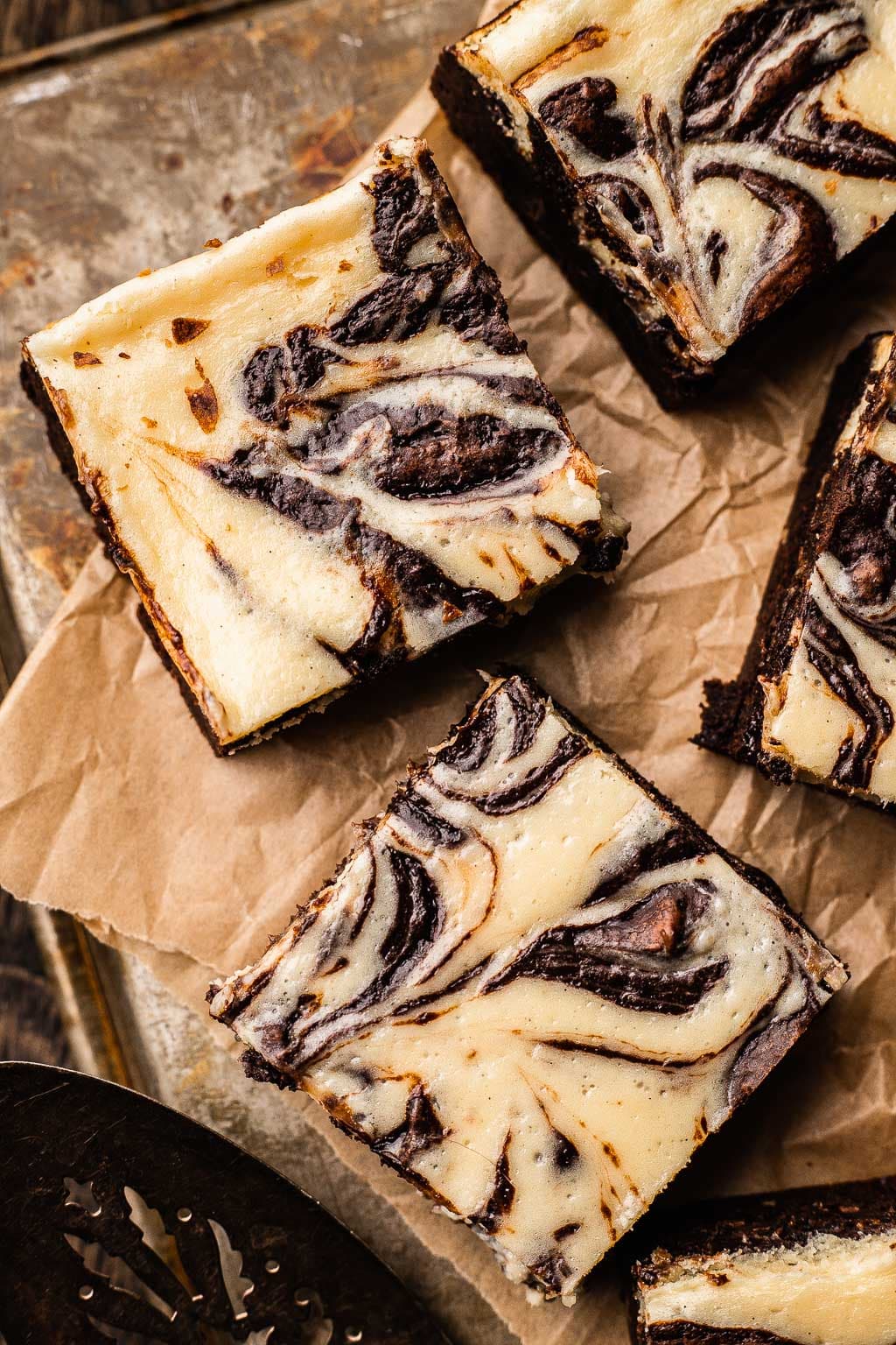 Overhead view of sliced marbled brownies on parchment paper