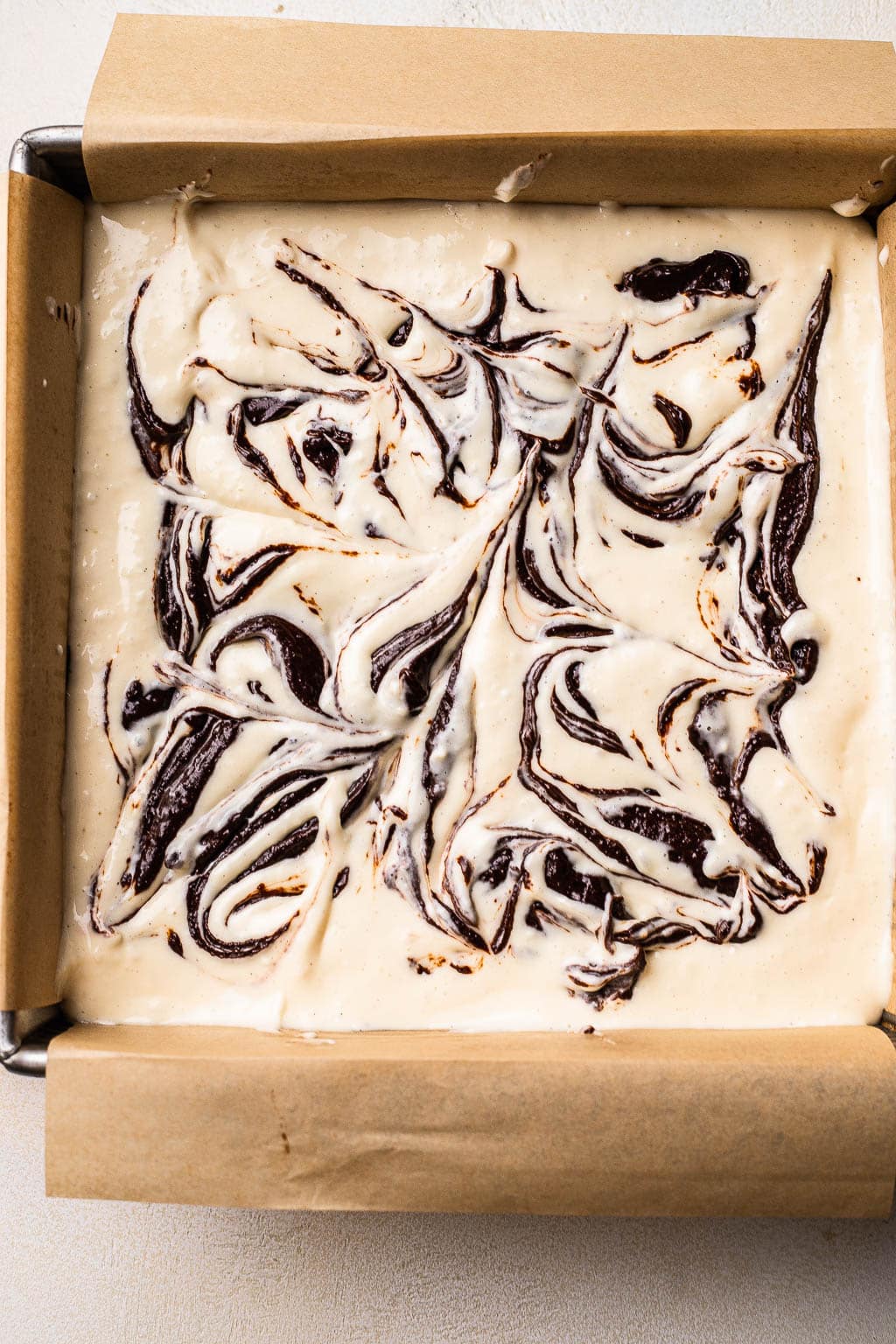 Brownies marbled with cheesecake filling, ready to be baked 