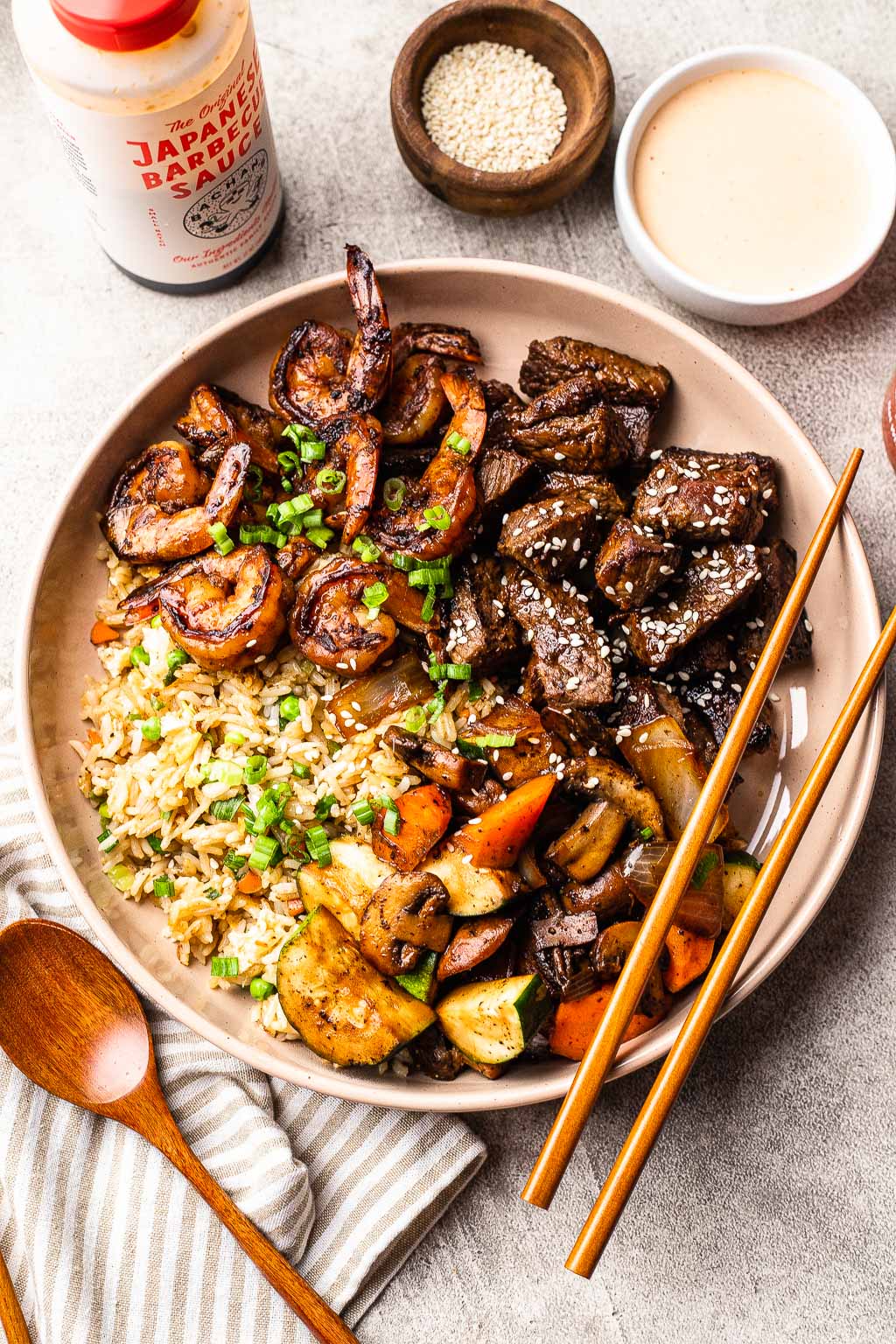 a steak and shrimp hibachi bowl over fried rice
