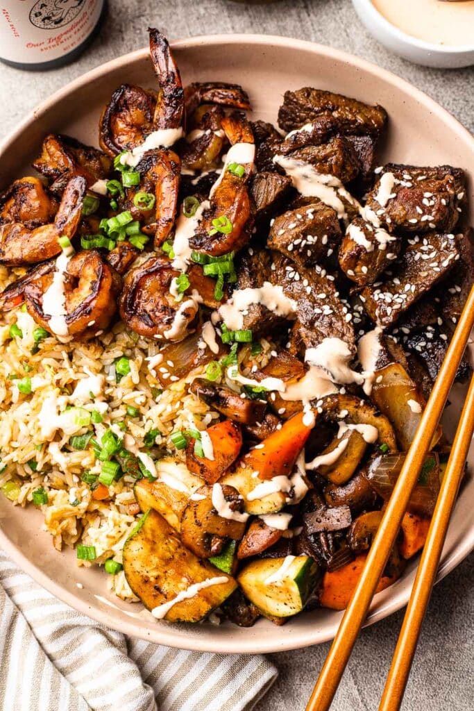 a steak and shrimp hibachi bowl over fried rice