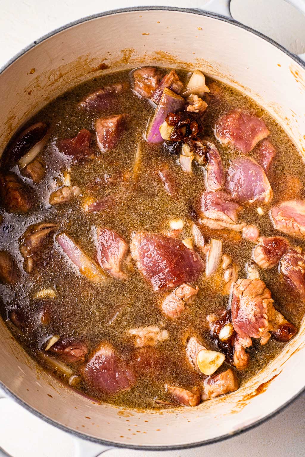 Pork and aromatics in a Dutch oven 