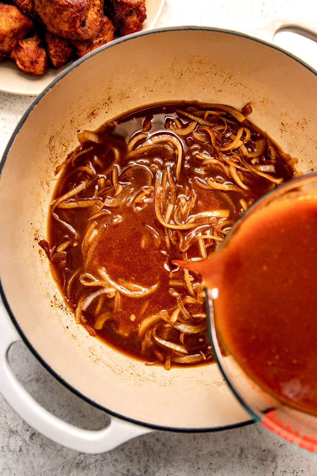 Onions and braising liquid in dutch oven