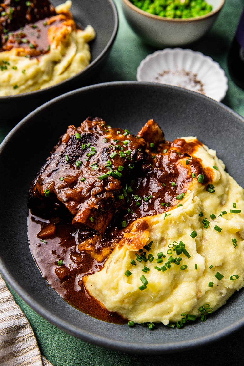 Braised short ribs in red wine sauce over a bed of mashed potatoes. 