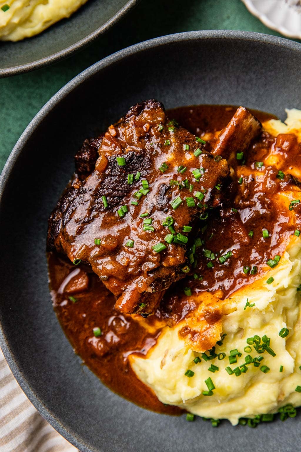 Braised short ribs in red wine sauce over a bed of mashed potatoes. 