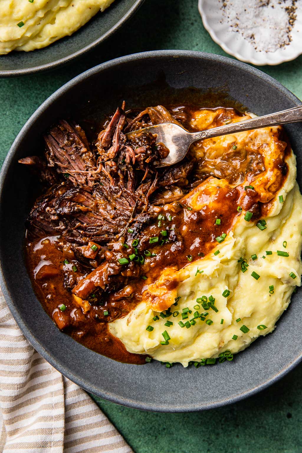 Braised short ribs in red wine sauce over a bed of mashed potatoes. 