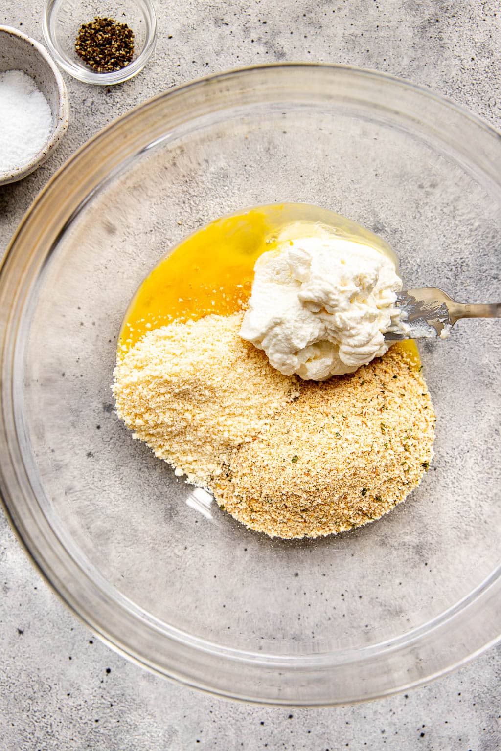 Ricotta, breadcrumbs, and egg in a bowl 