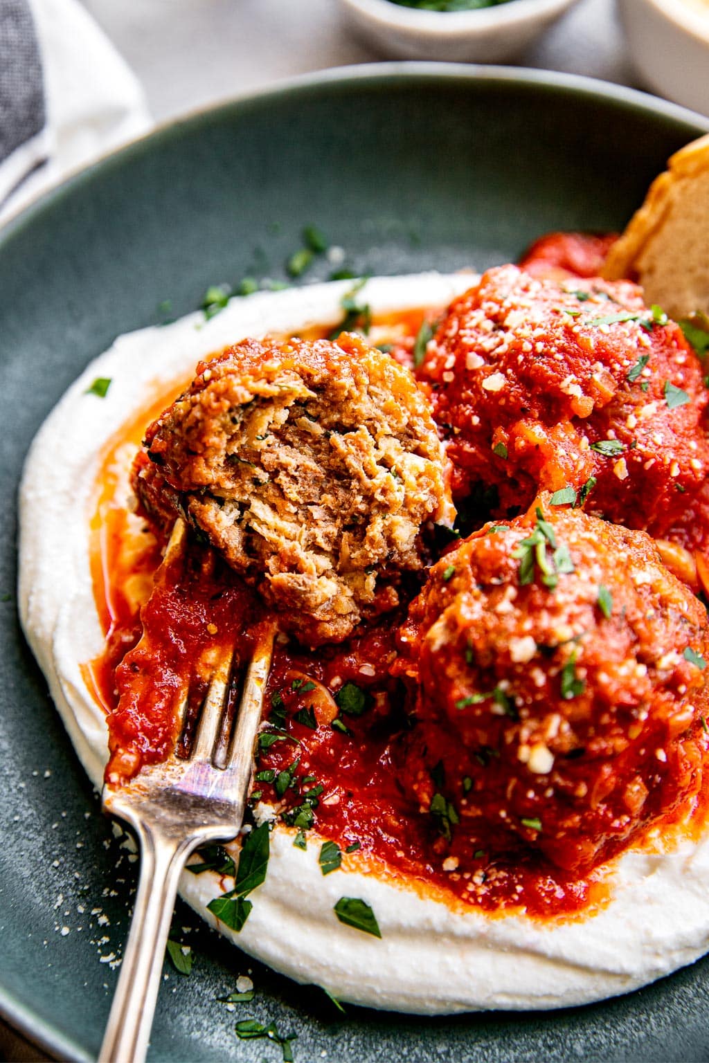 ricotta cheese meatballs on a bed of whipped ricotta