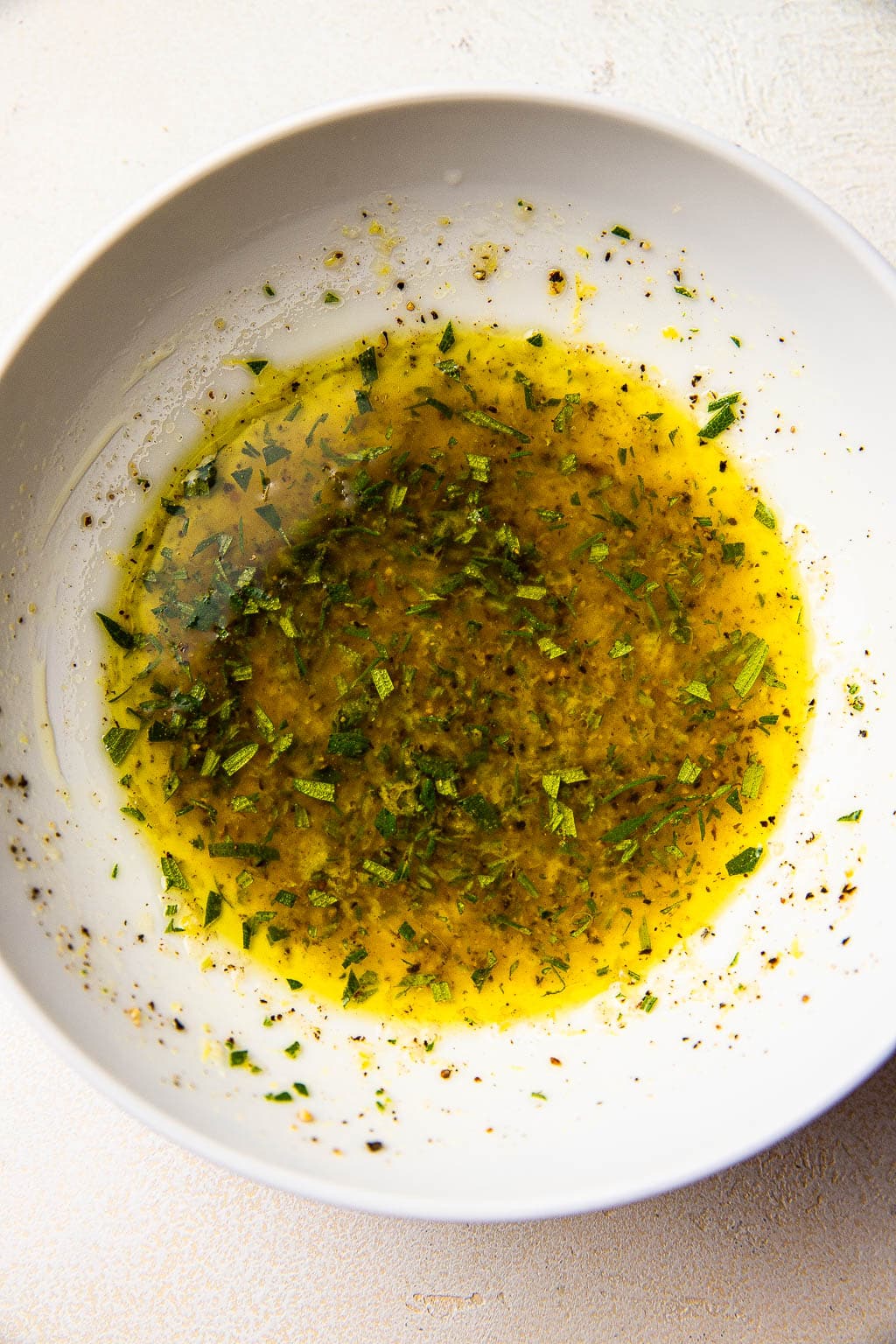 Lemon and oil mixture in mixing bowl 