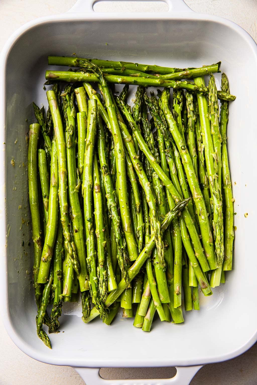 Asparagus spears marinating in lemon mixture 