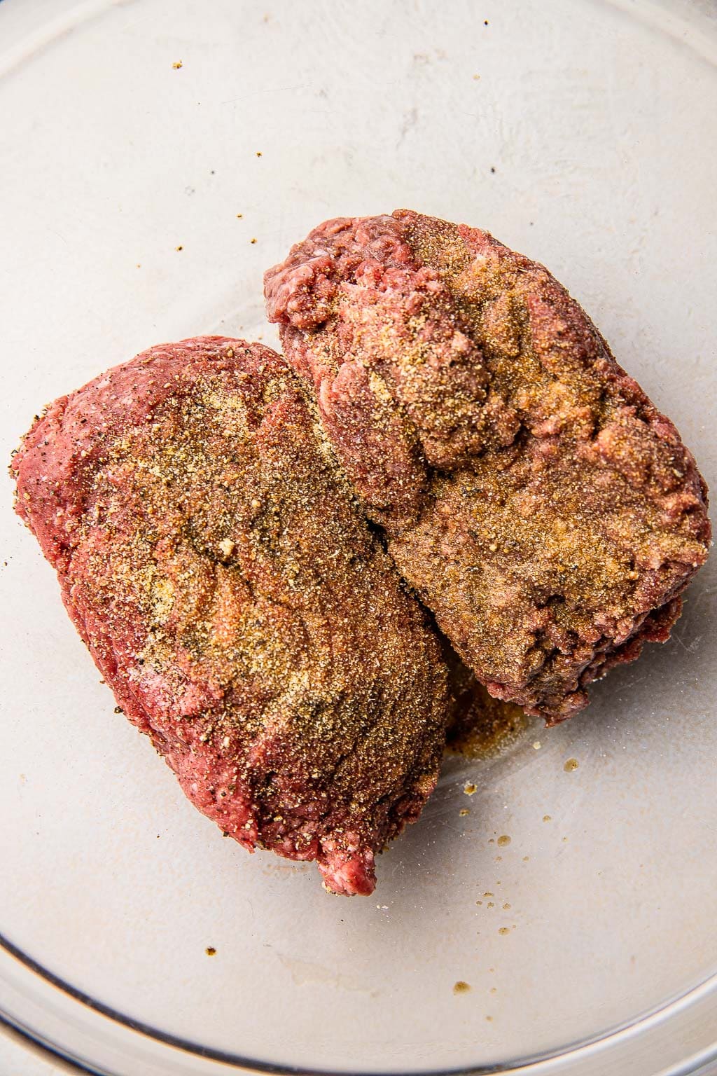 Ground beef and seasonings in a bowl 