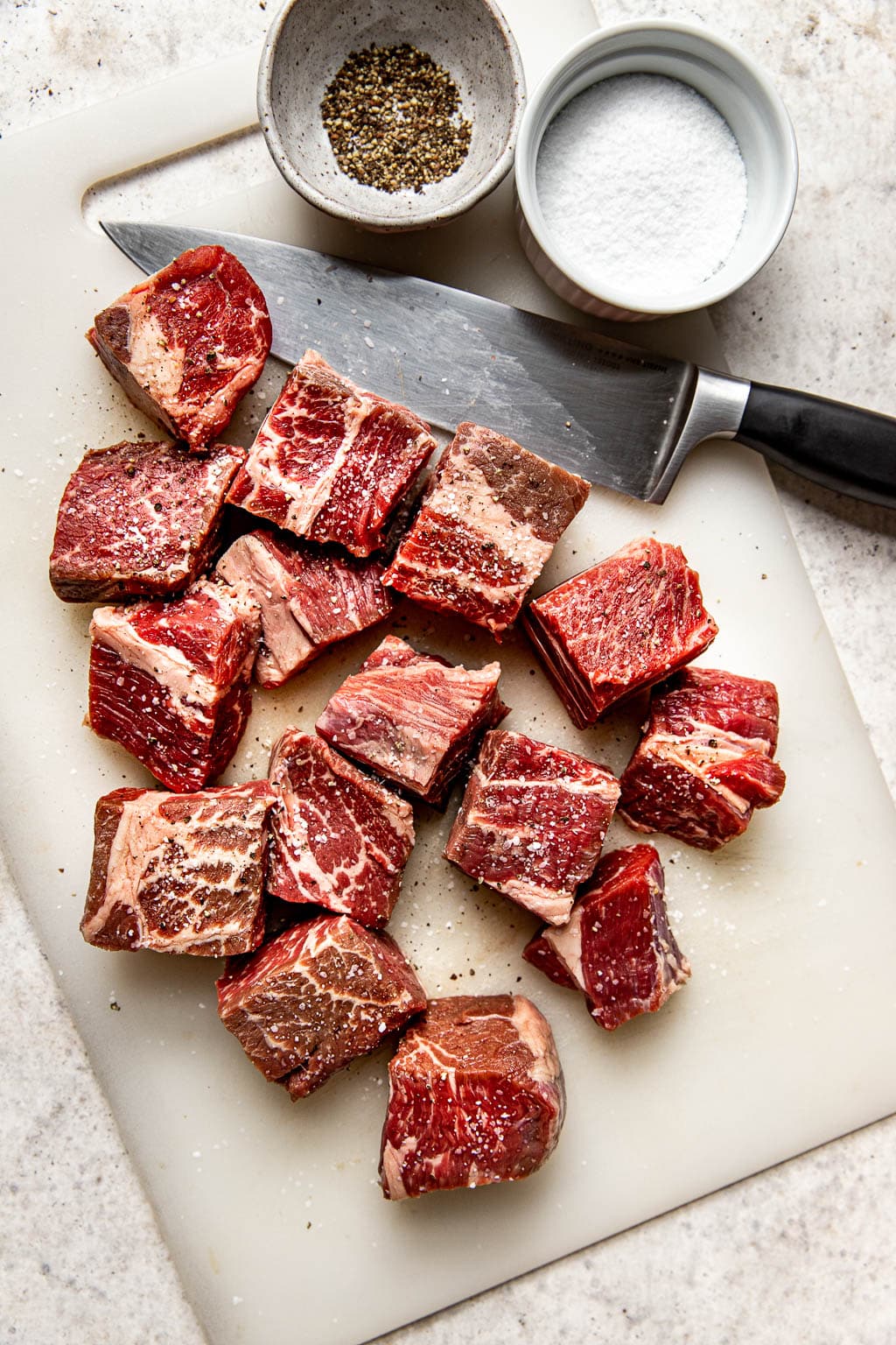Cubes of chuck roast seasoned with salt and pepper 