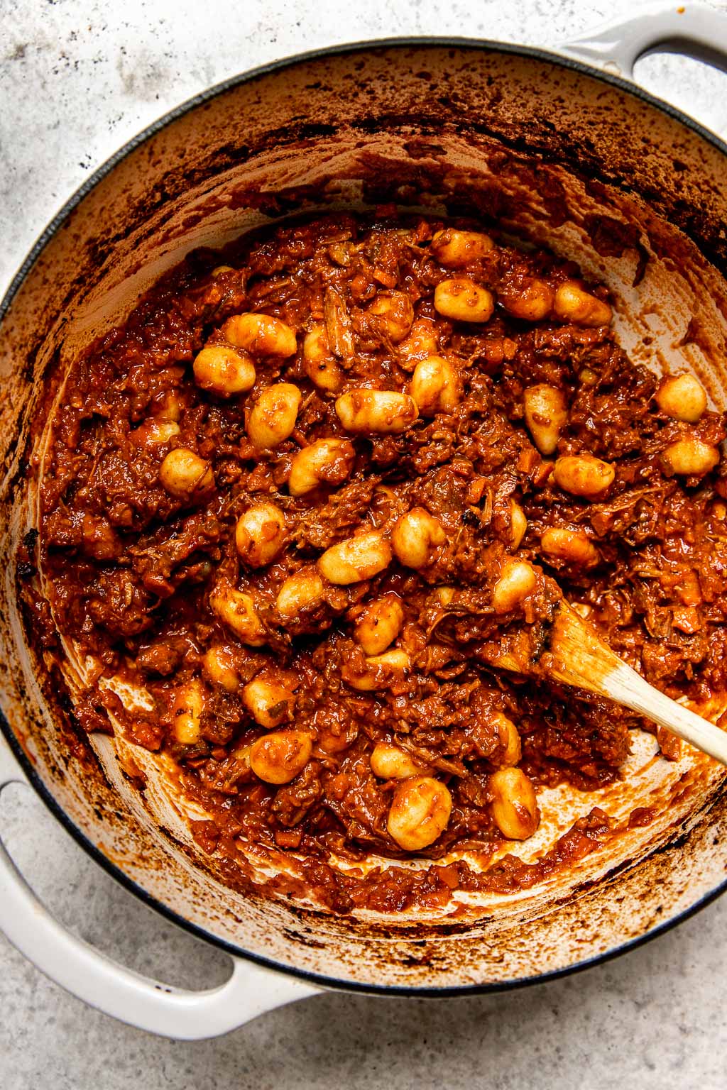 gnocchi tossed in shredded beef ragu in a Dutch oven 